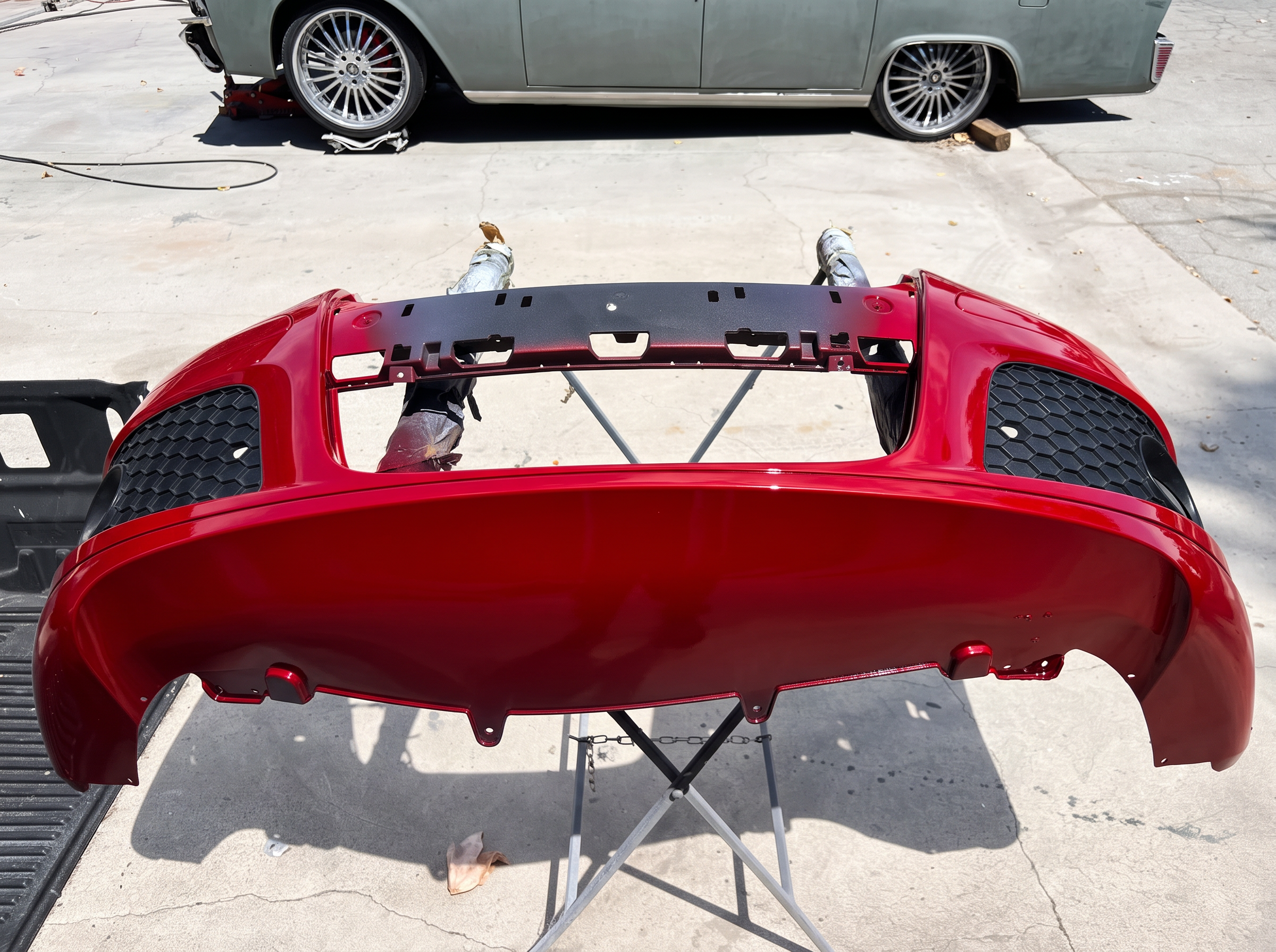 Freshly painted red rear bumper cover at LTP Auto Body