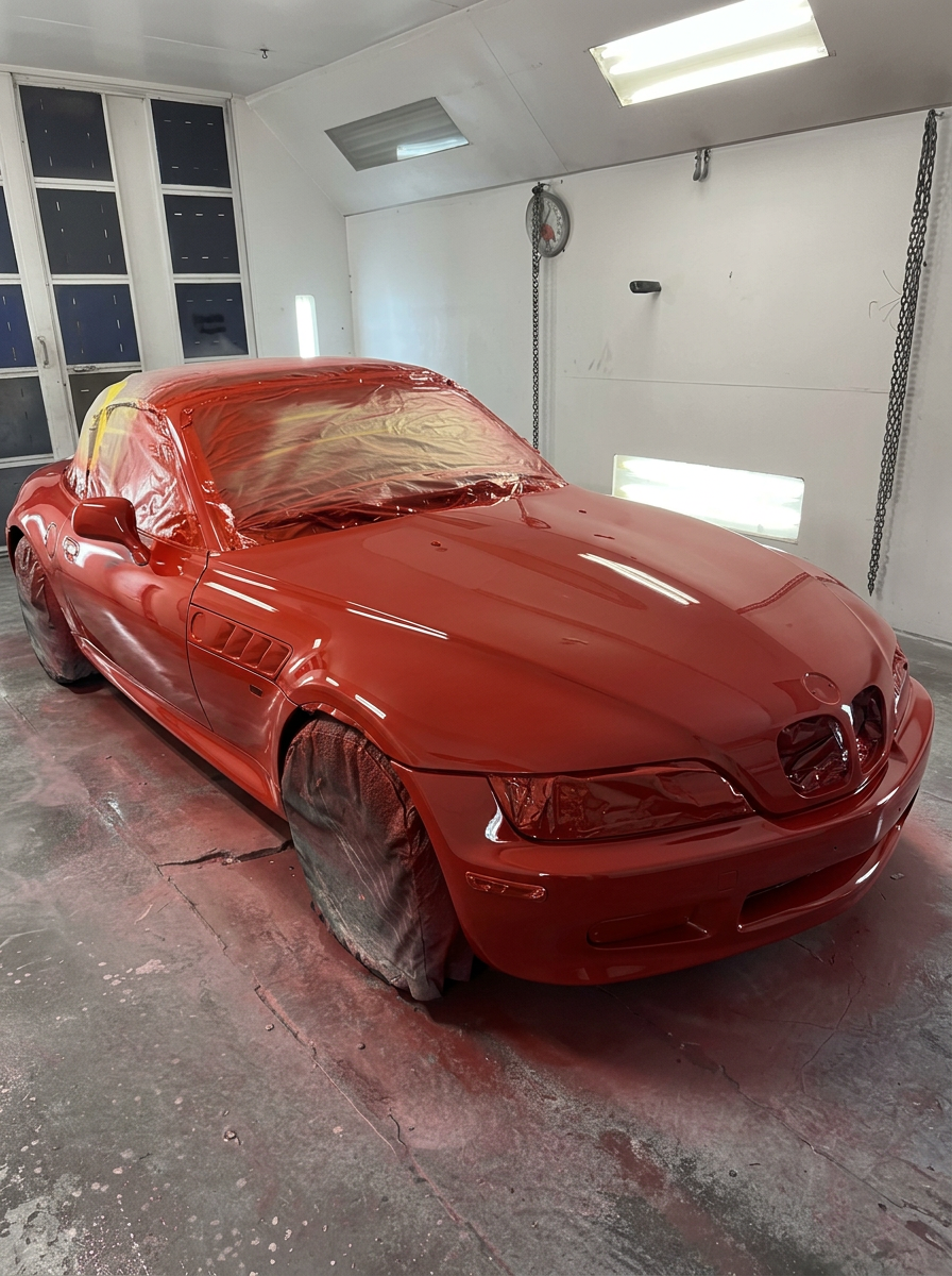 Freshly painted red convertible in the LTP Auto Body paint booth
